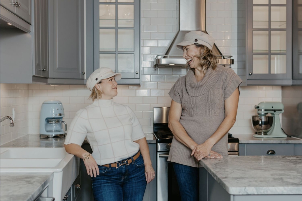 Wendy and Tatiana smiling at each other kitchen